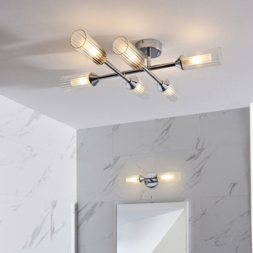 Bathroom with chrome ceiling light fixture, marble-patterned tiles, and rectangular mirror.