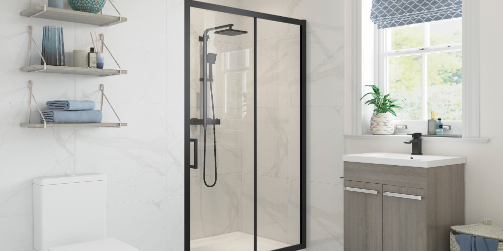 Bathroom with marble walls, black-framed sliding door shower, wooden vanity, shelves with towels and decor.