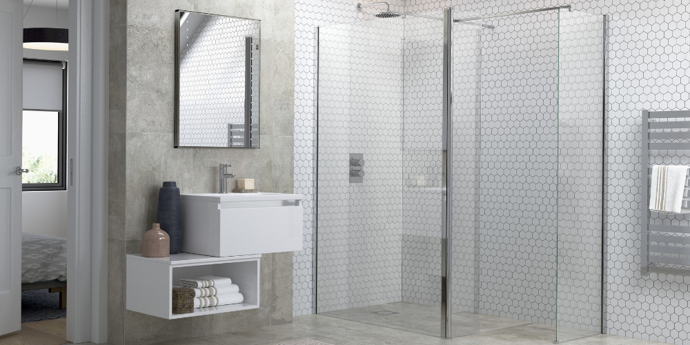 Wet room with hexagonal tile glass shower, wall-mounted sink and mirror, towels neatly stored below.
